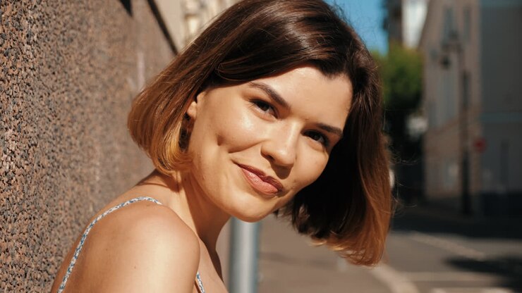 Woman wearing sunglasses in city street