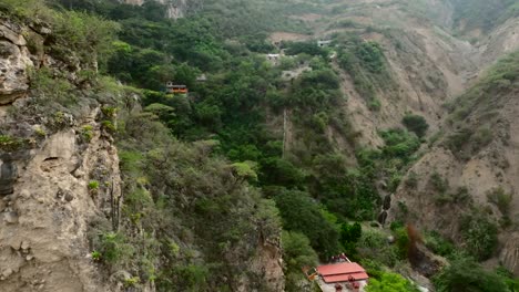 Dolly-in-proximity-drone-aerial-view-of-the-La-Gloria-and-Tolantongo-waterfalls,-Mezquital-Canyon,-Mexico