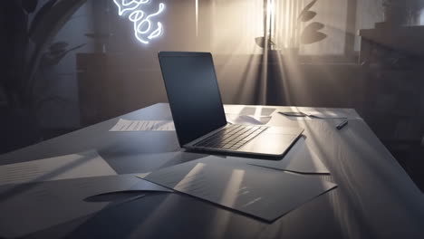 sunlit modern workspace with laptop and papers