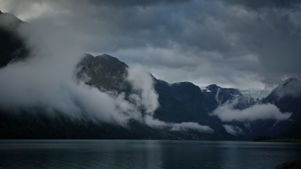 A landscape of calm waters Norway fjord covered with morning clouds