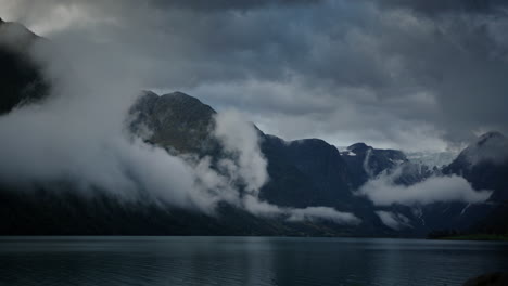 a landscape of calm waters norway fjord covered with morning clouds