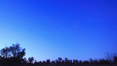 starry sky from sunset to dark. the night movement of stars in a circle around the polar star.