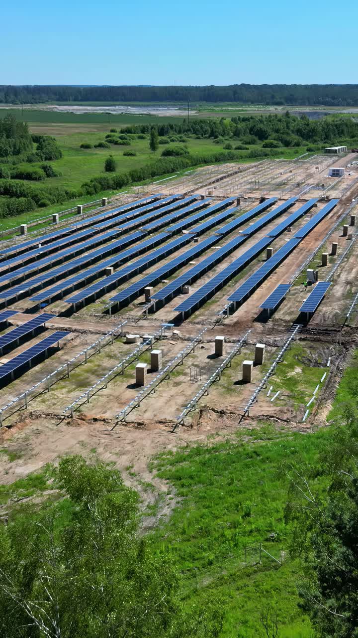 Aerial view of solar farm set in a rural landscape on a bright, clear day in Latvia