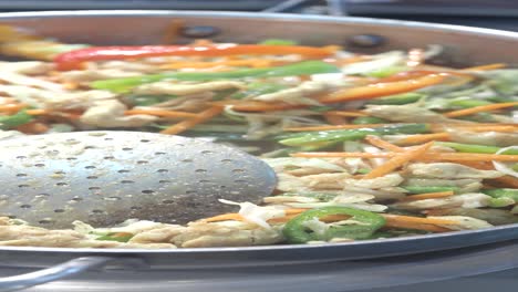 stir-frying chicken and vegetables