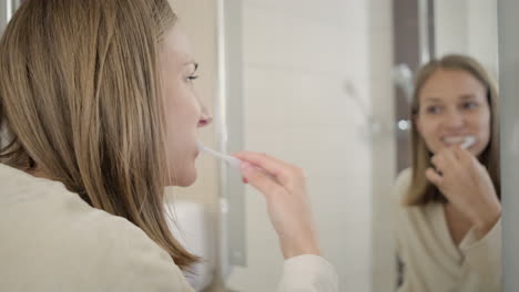 woman brushing her teeth