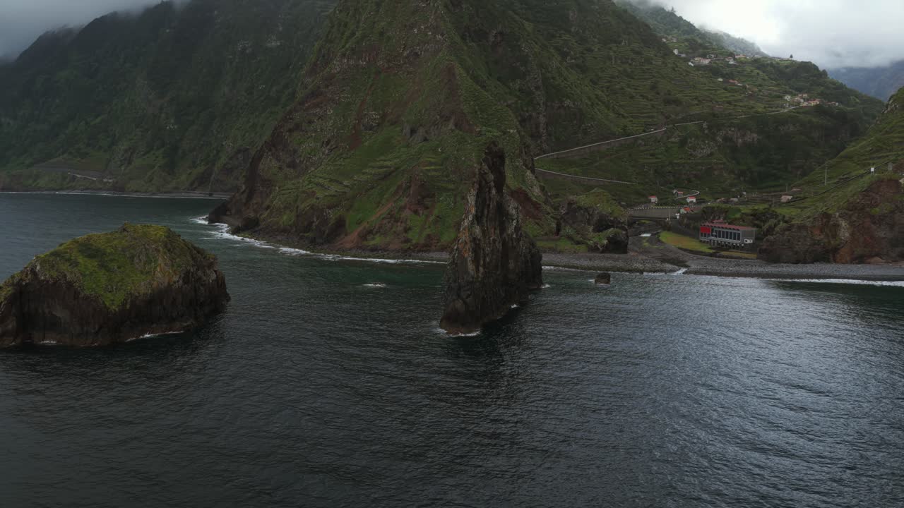 Ribeira da Janela rocky coastline and Ilheu Mole island emerging from Atlantic ocean in Madeira, Portugal. Aerial