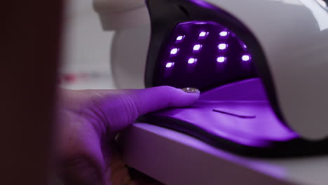 applying nail polish under uv lamp