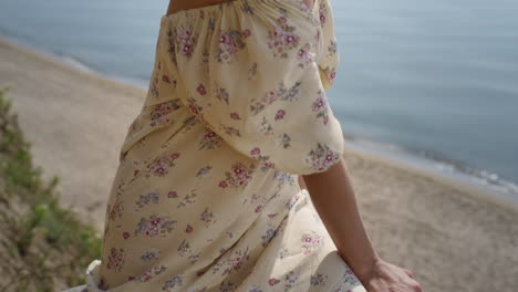 adorable woman relax on beach wearing flowery dress closeup. portrait curly girl