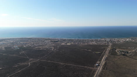 Great aerial shot of Las Grutas, Rio Negro, Patagonia Argentina. Panoramic view of the access road to the city with the sea in the background and a completely clear horizon.