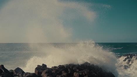 powerful waves crashing against rocks