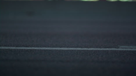 City-carriageway-marking-on-asphalt-road-closeup.-Solid-white-line-ending.