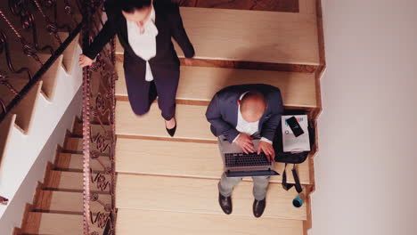 top view of company manager doing research sitting on stair