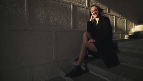 woman sitting on stairs at night