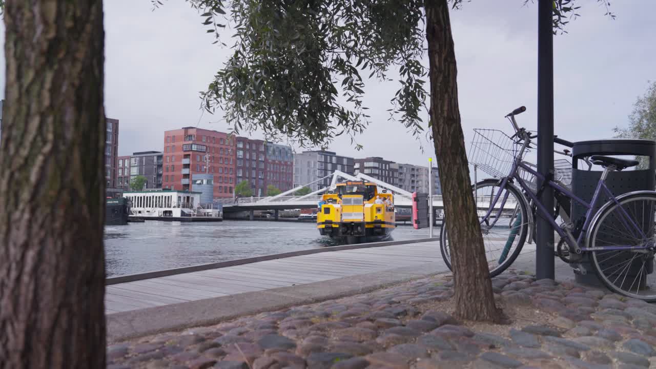 Yellow Copenhagen harbor bus float and change direction on water, Denmark