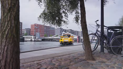 yellow copenhagen harbor bus float and change direction on water, denmark