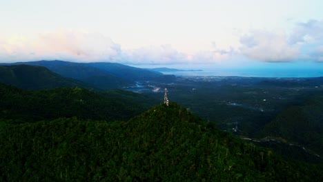 panoramic view of mount cagmasuso peak and satellite tower overlooking tropical island catanduanes, philippines during sunset - aerial orbit