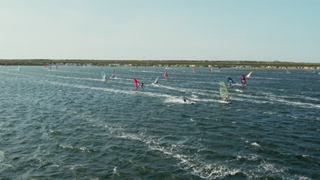 Windsurfers-On-A-Race-At-The-Beach-Of-Grevelingenmeer-Surfspot-In-Zeeland,-The-Netherlands