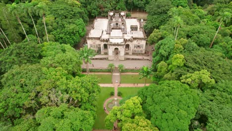 Aerial-view-of-Scenic-Parque-Lage-mansion-surrounded-by-tropical-lush-vegetation,-Rio-de-Janeiro