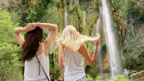 happy friends at a waterfall