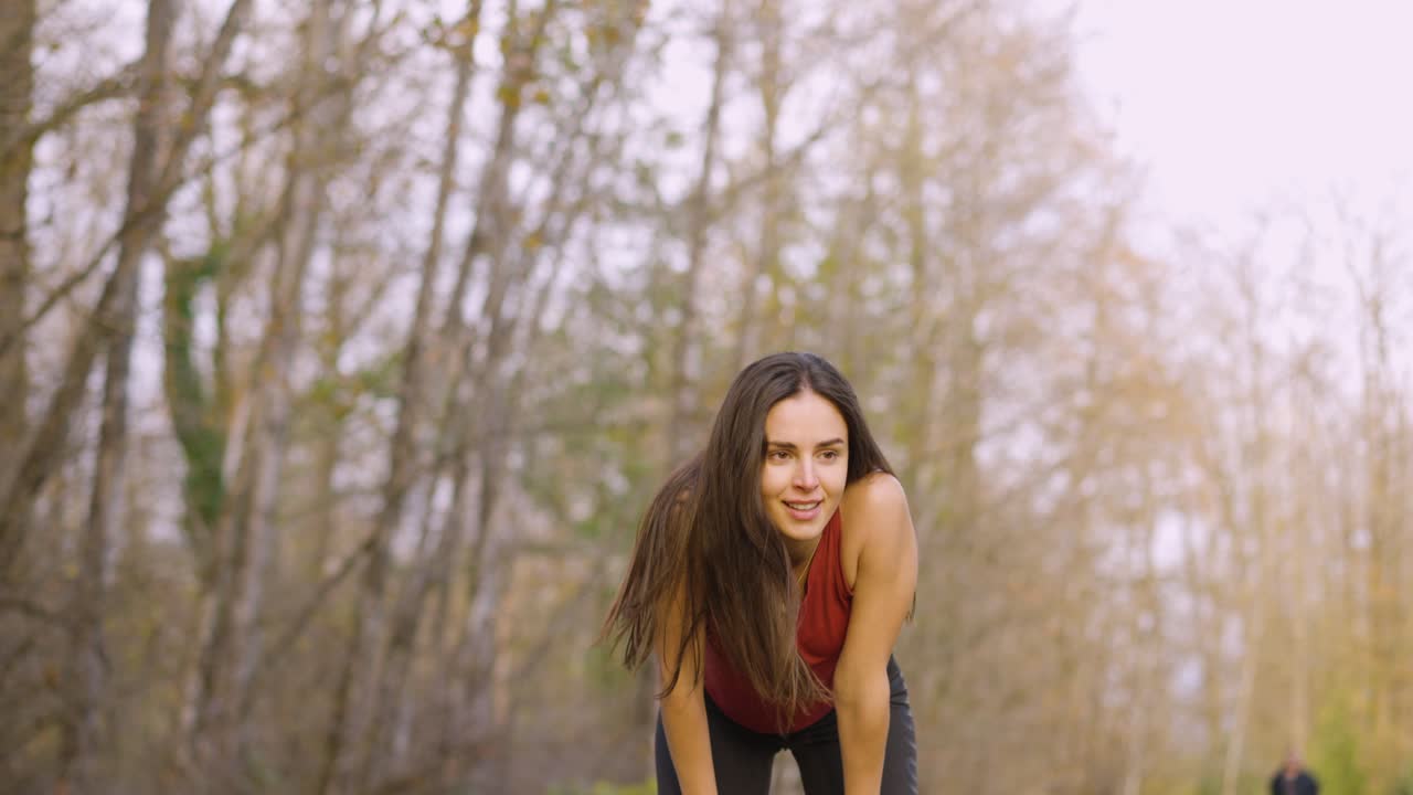 a woman taking a breather after running for some time.
