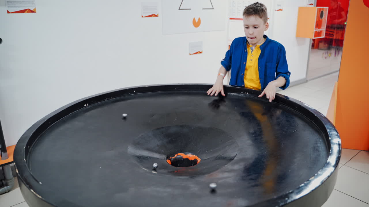 Boy in the museum science. A planet swallowed by black hole simulation, endless gravity
