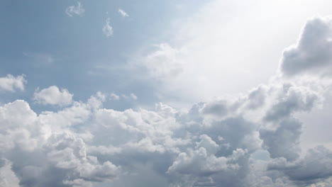 Wide-angle-of-clouds-slowly-moving-across-a-clear-blue-sky