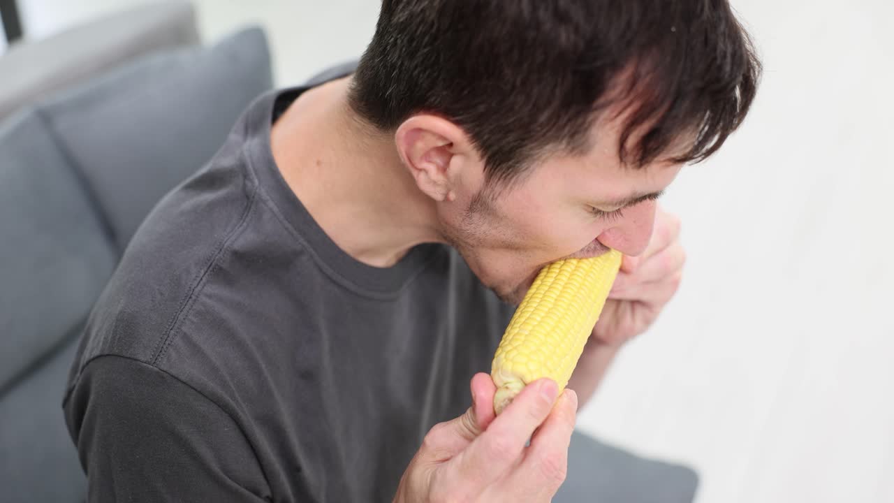 Man eating corn on the cob