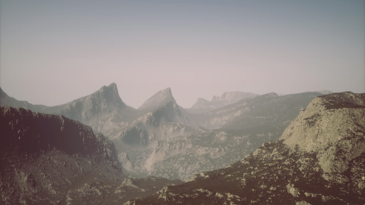 Majestic mountain range shrouded in mist during early morning light