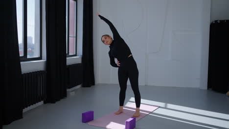 woman practicing yoga in a studio