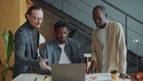 business team discussing project on laptop in office