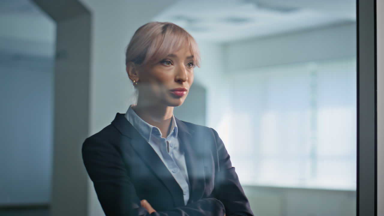 Elegant businesswoman standing office hall with determined expression closeup