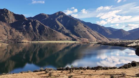 tranquil lake moke with mountain reflections under clear skies. captured in queenstown, new zealand, showcasing natural beauty and calmness