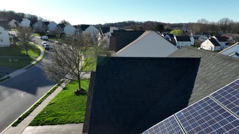 roof solar panels on house in american residential area at sunset