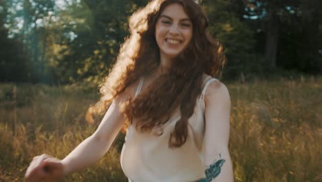 pov: a young woman is holding someone's hand and following the camera while running through a tall grass field