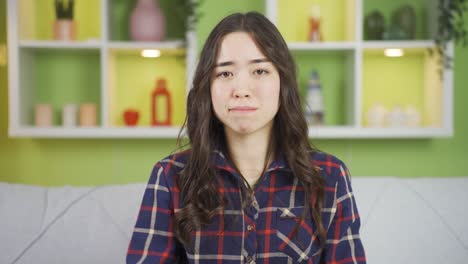 unhappy asian young woman looking at her face.
