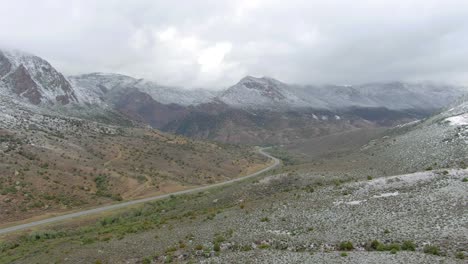 Aerial-dolly-zoom-of-snowy-mountain-road