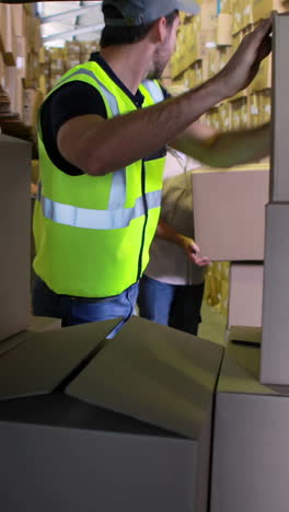 delivery driver loading his van with boxes