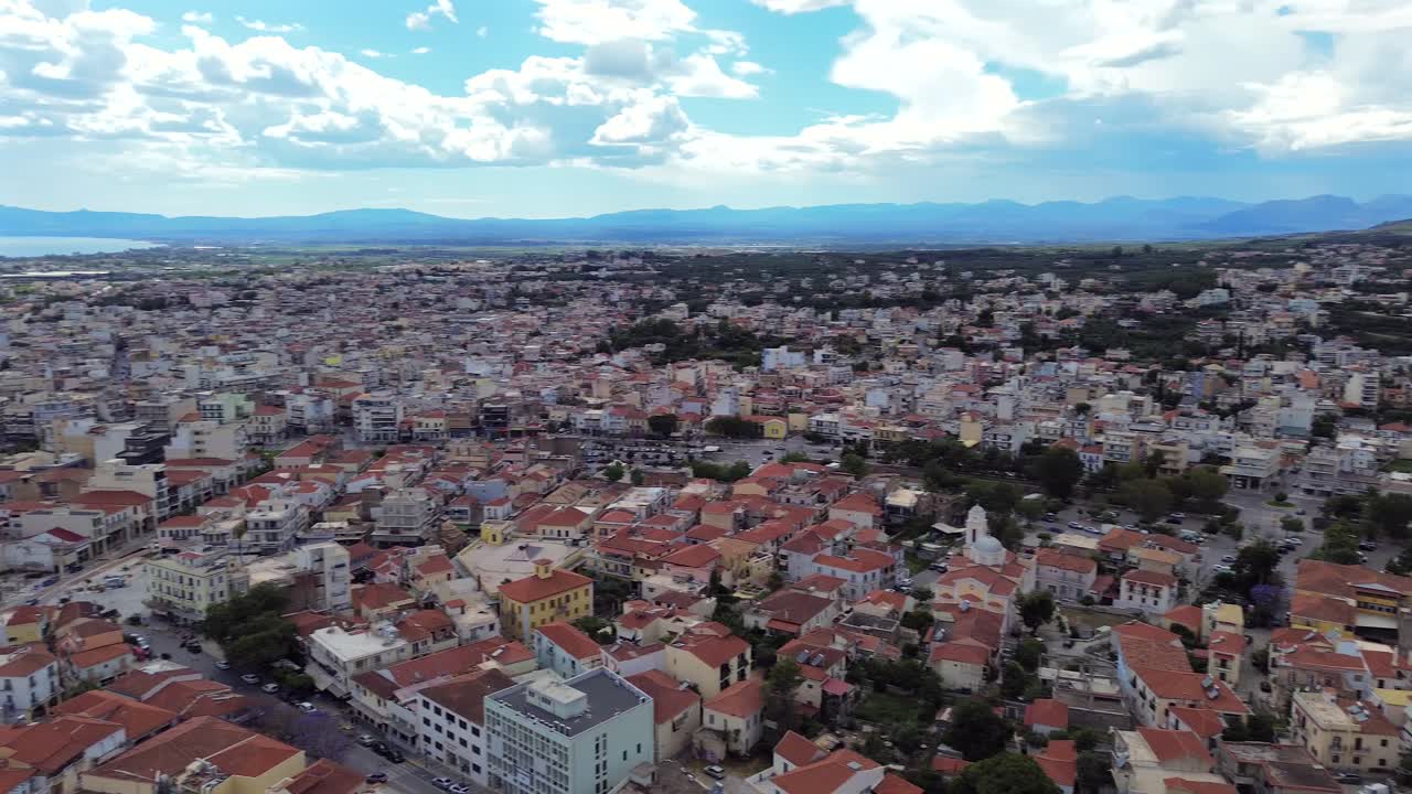 Aerial wide panoramic view, Kalamata cityscape , slow right pan and tilt down drone movement, revealing historical center of the city 4K