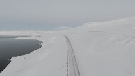 winter country road from above and full moon in sky, dolly forward