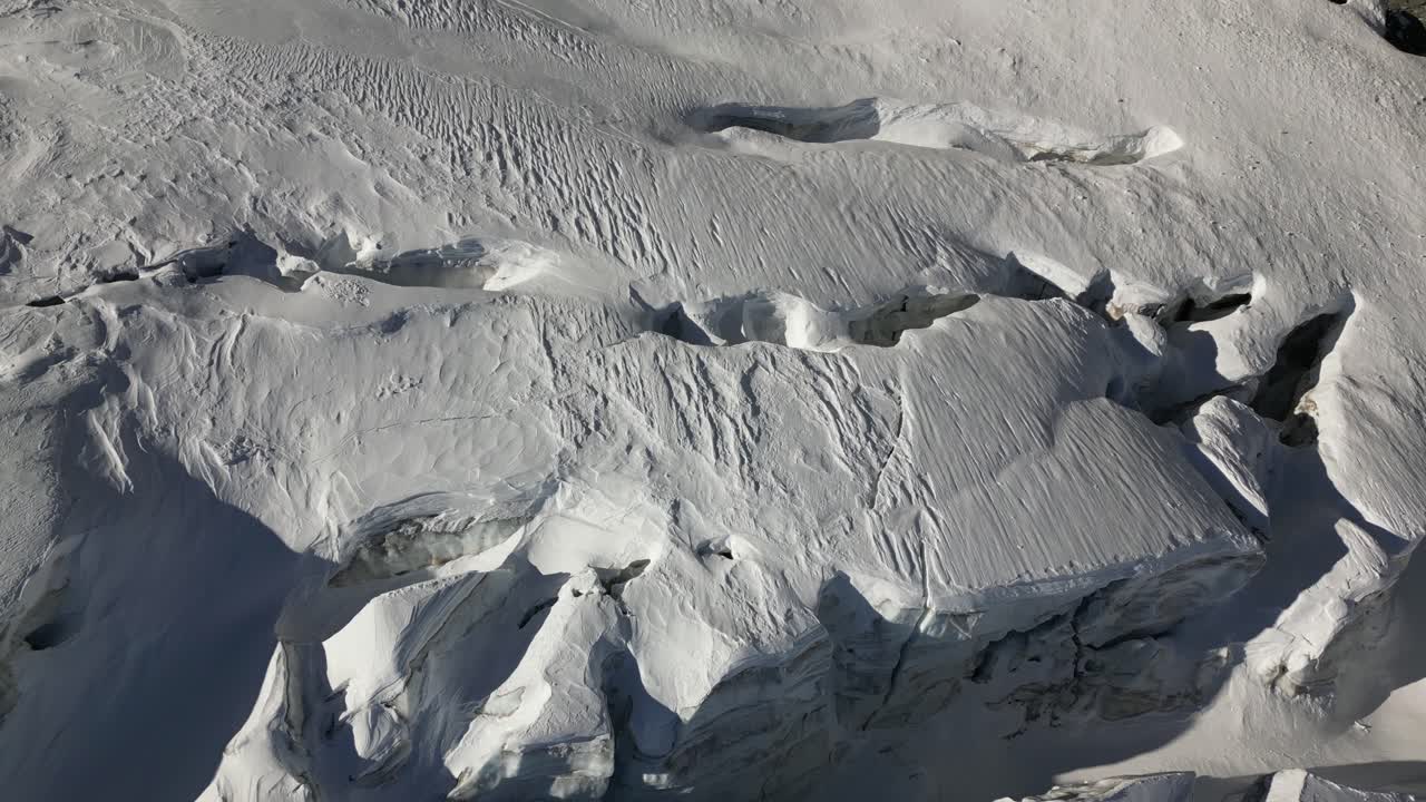 aerial view, snow-covered mountain ground, crevasses are hidden with the powder
