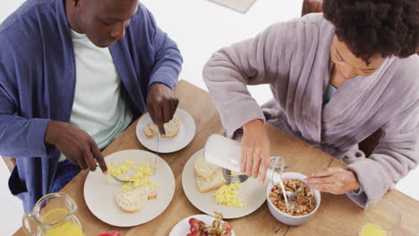Video of happy african american couple eating breakfast together