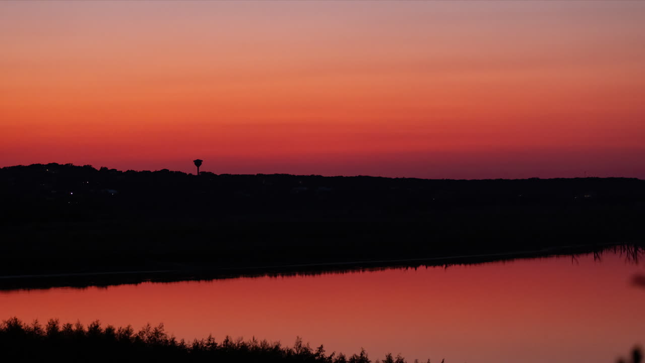 Dramatic, colorful Timelapse of the twilight just after sunset in canon lake, Texas in the hill country
