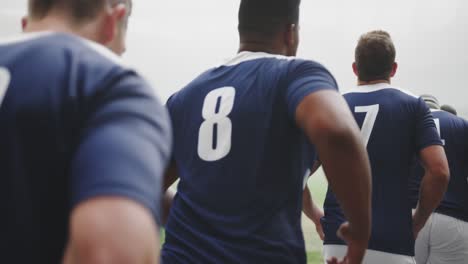 male rugby players running in row at the stadium 4k