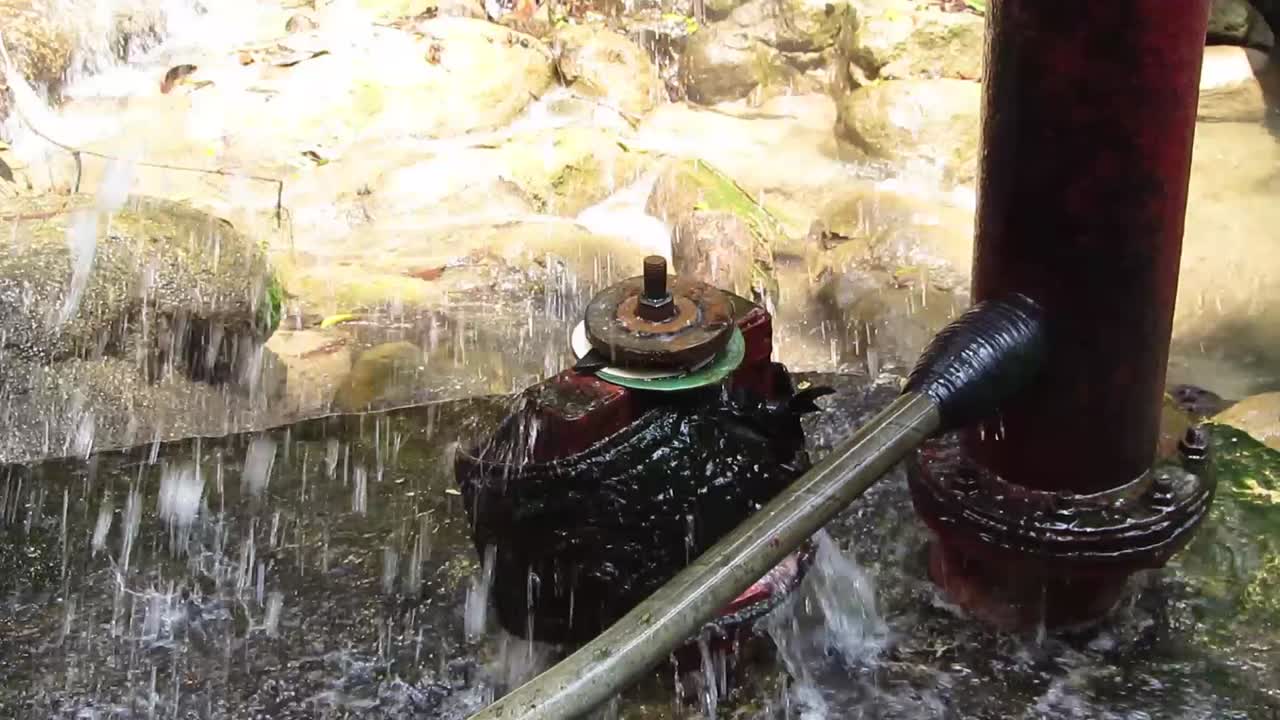 An ancient Dutch water pump near a water source, West Java, Indonesia