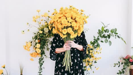 woman with a big bouquet of yellow flowers