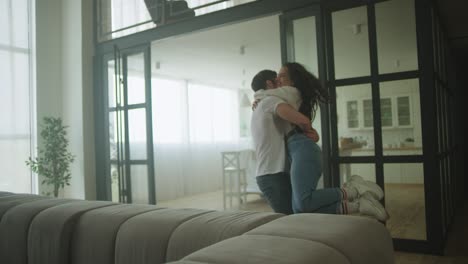 happy couple spinning around in new home. cheerful couple celebrating relocation