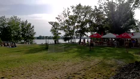 people having a good time at the lakeshore enjoying a summer day