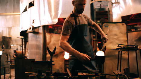 glassblower shaping a molten glass