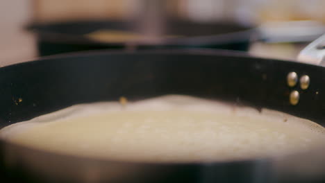 frying pancake in pan close-up