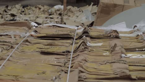 cardboard waste in bales medium panning shot